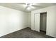 Clean bedroom with neutral carpet, ceiling fan, closet, and neutral paint at 1721 Mill Canyon Dr, Las Vegas, NV 89128