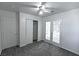 Cozy bedroom featuring a ceiling fan, closet, and glass patio doors for natural light at 1721 Mill Canyon Dr, Las Vegas, NV 89128