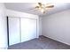 Bedroom with carpet, closet with sliding doors, and ceiling fan at 1721 Mill Canyon Dr, Las Vegas, NV 89128