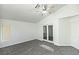 Bedroom with ceiling fan, plush carpet, bright walls, and glass-paneled double doors at 1721 Mill Canyon Dr, Las Vegas, NV 89128