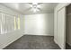 Bright bedroom with carpet flooring, closet, and a large window at 1721 Mill Canyon Dr, Las Vegas, NV 89128