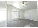 Bright bedroom with vaulted ceiling, ceiling fan, neutral walls, plush carpet, and vertical blinds at 1721 Mill Canyon Dr, Las Vegas, NV 89128