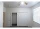 Well-lit bedroom with neutral paint, closet, ceiling fan, and a bright window at 1721 Mill Canyon Dr, Las Vegas, NV 89128