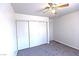 Bedroom with carpet, closet with sliding doors, and ceiling fan at 1721 Mill Canyon Dr, Las Vegas, NV 89128