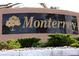 Monterey community sign featuring a tree and gold lettering, set against desert landscaping at 1721 Mill Canyon Dr, Las Vegas, NV 89128
