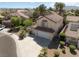 Aerial view showcasing a charming desert home with a tile roof and mature landscaping at 1721 Mill Canyon Dr, Las Vegas, NV 89128