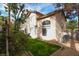 Back exterior view of home showing the second story, lawn and partial trees at 1721 Mill Canyon Dr, Las Vegas, NV 89128