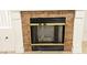 Close up of brick fireplace with decorative white trim and a glass door at 1721 Mill Canyon Dr, Las Vegas, NV 89128