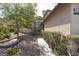 Front entrance is a welcoming stone walkway with mature landscaping and flowerbeds at 1721 Mill Canyon Dr, Las Vegas, NV 89128