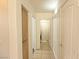 Hallway featuring storage closet and tile flooring, connecting to various rooms at 1721 Mill Canyon Dr, Las Vegas, NV 89128