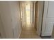 Hallway with tile floors, storage closet, and doors leading to other rooms at 1721 Mill Canyon Dr, Las Vegas, NV 89128
