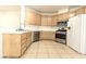 Corner kitchen with wood cabinets, stainless appliances and white tile countertop at 1721 Mill Canyon Dr, Las Vegas, NV 89128