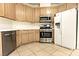 Well-lit kitchen features light wood cabinets, stainless appliances, and tiled flooring at 1721 Mill Canyon Dr, Las Vegas, NV 89128