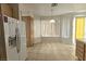 The kitchen has tile flooring, oak cabinets and a large window with white blinds at 1721 Mill Canyon Dr, Las Vegas, NV 89128
