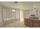 Open floor plan with tile floors, oak cabinets and large window with white blinds at 1721 Mill Canyon Dr, Las Vegas, NV 89128