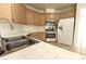 Kitchen featuring oak cabinets, tile countertops, and stainless-steel appliances at 1721 Mill Canyon Dr, Las Vegas, NV 89128