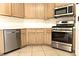 Close up view of light wood kitchen cabinets and stainless steel appliances at 1721 Mill Canyon Dr, Las Vegas, NV 89128