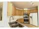 Traditional-style kitchen with stainless steel appliances, oak cabinets, and tile backsplash at 1721 Mill Canyon Dr, Las Vegas, NV 89128