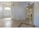 Spacious living area with tile flooring, chandelier, and views to other rooms at 1721 Mill Canyon Dr, Las Vegas, NV 89128