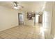 Open floorplan combines living room and kitchen area with tile floor and neutral paint at 1721 Mill Canyon Dr, Las Vegas, NV 89128