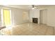 Spacious living room boasts neutral tile flooring and a cozy brick fireplace at 1721 Mill Canyon Dr, Las Vegas, NV 89128