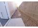 Narrow side yard featuring gravel landscaping with a path and a privacy wall at 1721 Mill Canyon Dr, Las Vegas, NV 89128