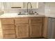 Close up of kitchen sink with double basin, wood cabinets and tile countertop at 1721 Mill Canyon Dr, Las Vegas, NV 89128