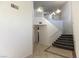 Carpeted staircase with white railing leads to the upper level of this modern home at 1721 Mill Canyon Dr, Las Vegas, NV 89128
