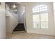 Bright foyer featuring carpeted stairs with tile flooring and large windows at 1721 Mill Canyon Dr, Las Vegas, NV 89128