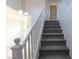Carpeted staircase with white railing at 1721 Mill Canyon Dr, Las Vegas, NV 89128
