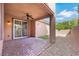 Covered back patio featuring brick and gravel groundcover with a ceiling fan at 1976 Galleria Spada St, Henderson, NV 89044