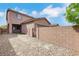 Rear exterior view of the home showcasing backyard with gravel, patio and block wall at 1976 Galleria Spada St, Henderson, NV 89044