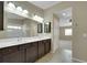 Bathroom featuring double sinks, a mirror, and a doorway to another room at 1976 Galleria Spada St, Henderson, NV 89044
