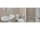 Cozy half bathroom with a pedestal sink, toilet, and a doorway to another room at 1976 Galleria Spada St, Henderson, NV 89044