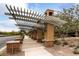 Stylish entrance with a trellis, desert plants, and a walkway, creating an inviting and attractive community gateway at 1976 Galleria Spada St, Henderson, NV 89044