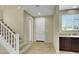 Bright home entryway with tiled floor, staircase, and convenient sink area at 1976 Galleria Spada St, Henderson, NV 89044