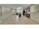 Open-concept floor plan connecting the living room, dining area, and kitchen with tile floors at 1976 Galleria Spada St, Henderson, NV 89044