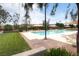 Beautiful community pool with lounge chairs, umbrellas, and grassy areas, perfect for relaxation and recreation at 1976 Galleria Spada St, Henderson, NV 89044