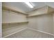 Walk-in closet offering carpet flooring and wooden shelving at 1976 Galleria Spada St, Henderson, NV 89044