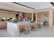 Stylish kitchen featuring a waterfall island with seating, modern appliances, custom cabinets, and an adjacent wine storage unit at 20 Lakefront Dr, Henderson, NV 89011