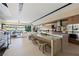 Modern open floorplan featuring sleek kitchen with an island and adjacent living area with sliding glass doors to the outdoors at 20 Lakefront Dr, Henderson, NV 89011