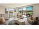 A modern living room area with stylish chairs, a table, and views of the lake at 20 Lakefront Dr, Henderson, NV 89011
