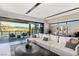 Open living area features modern furnishings, with a view of waterfront scenery, an adjacent dining space, and lots of natural light at 20 Lakefront Dr, Henderson, NV 89011