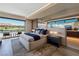 This primary bedroom features a luxurious space, water views, and balcony access at 20 Lakefront Dr, Henderson, NV 89011