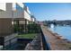 A waterfront view shows luxury residences and walkway bordering the water, complemented by garden features and a distant yacht at 20 Lakefront Dr, Henderson, NV 89011