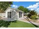 Backyard with a guest house, a manicured lawn and lush landscaping at 204 Canyon Dr, Las Vegas, NV 89107