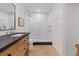 Modern bathroom featuring a glass shower, wooden vanity, and tile floors at 204 Canyon Dr, Las Vegas, NV 89107