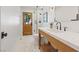 Bright bathroom features a glass shower, a sleek faucet and fixtures, and tile floors at 204 Canyon Dr, Las Vegas, NV 89107
