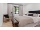 Bedroom featuring a comfortable bed, chair, and neutral decor at 204 Canyon Dr, Las Vegas, NV 89107