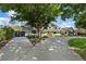 Grand estate featuring an expansive driveway, lush landscaping, and mature trees at 204 Canyon Dr, Las Vegas, NV 89107